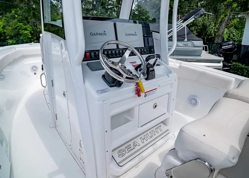 Slide: The Image of The image shows the helm of a Sea Hunt Gamefish 27CB boat with Garmin electronics. - 19
