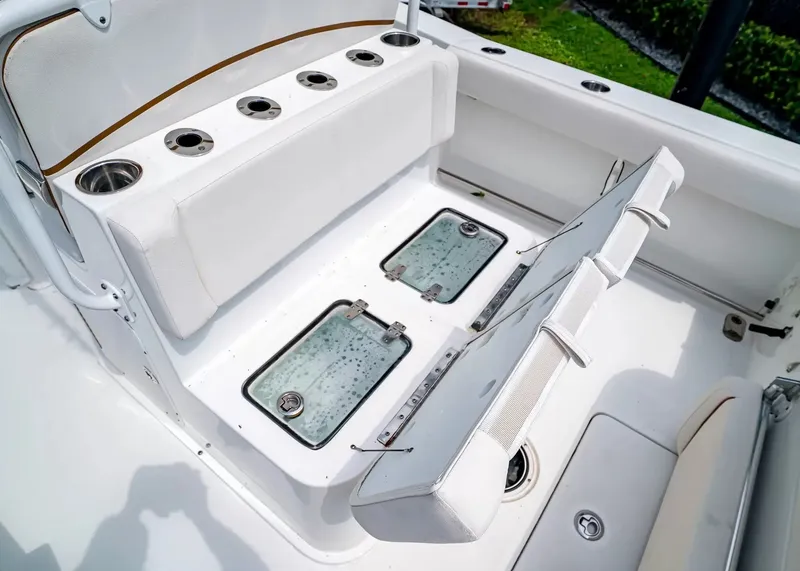 Slide: The Image of The image shows the seating area of a 2020 Sea Hunt Gamefish 27CB with built-in storage compartments. - 12