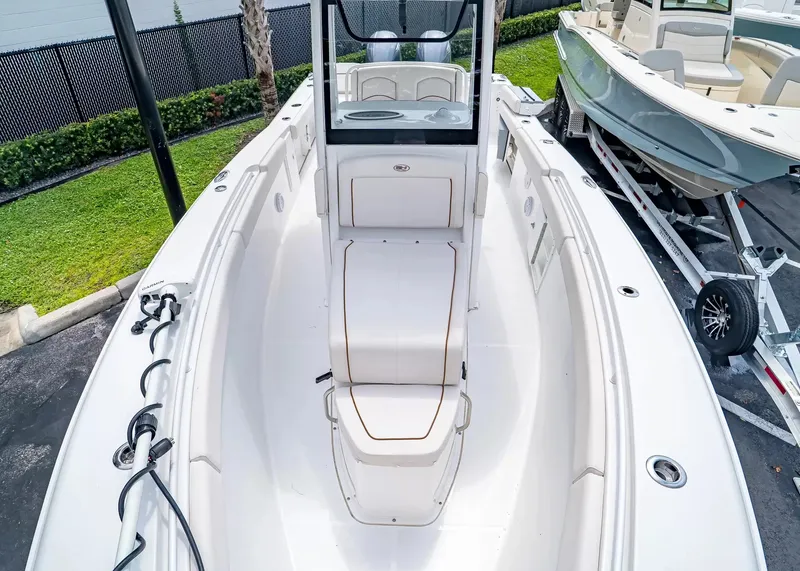 Slide: The Image of A 2020 Sea Hunt Gamefish 27CB with a spacious white deck and cushioned seating. - 28