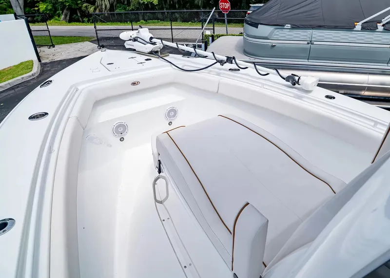 Slide: The Image of The image shows the bow of a 2020 Sea Hunt Gamefish 27CB with white upholstery. - 25
