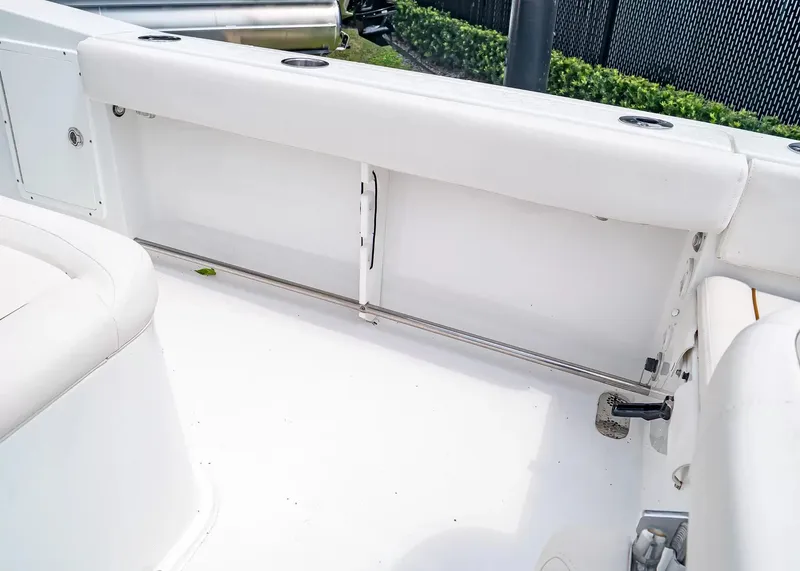 Slide: The Image of The image shows the white cockpit of a 2020 Sea Hunt Gamefish 27CB with cushioned seating. - 15