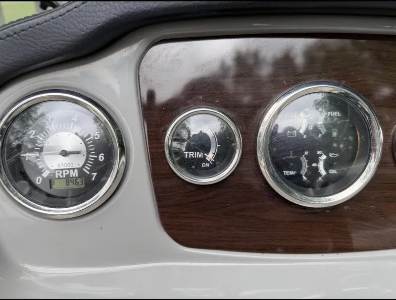Slide: The Image of The image shows the dashboard of a 2020 Chaparral SSi 21 boat with various gauges. - 15