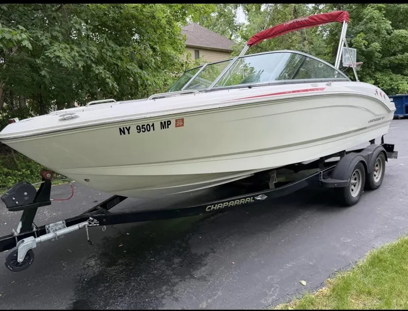 Slide: The Image of A white 2020 Chaparral SSi 21 boat on a trailer in a driveway. - 5