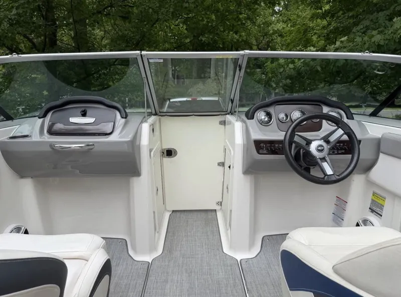 Slide: The Image of The image shows the cockpit of a 2020 Chaparral SSi 21 boat with gray and white seating. - 9