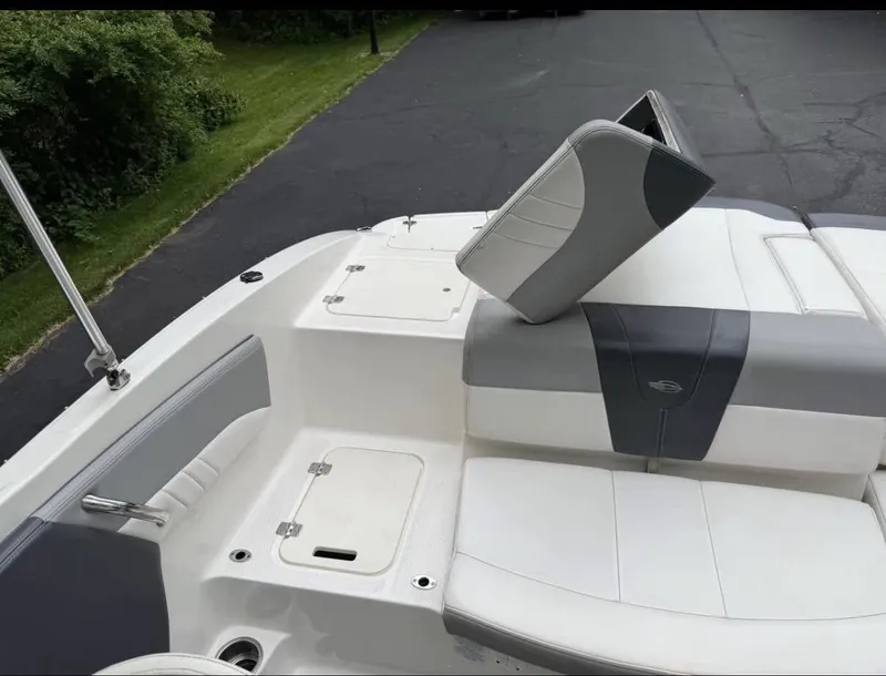 Slide: The Image of The image shows the stern of a 2020 Chaparral SSi 21 boat with white and gray upholstery. - 8