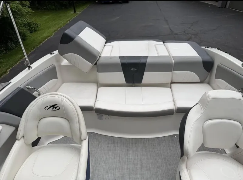 Slide: The Image of The image shows the cockpit of a 2020 Chaparral SSi 21 boat with white and gray seating. - 11