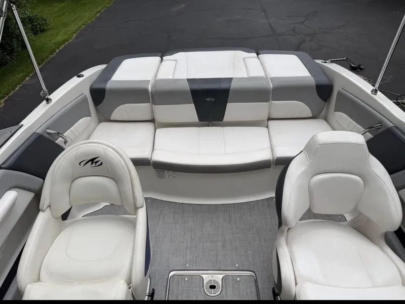 Slide: The Image of The image shows the cockpit of a 2020 Chaparral SSi 21 boat with white and gray seating. - 12