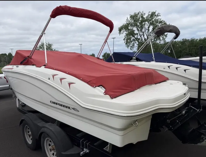 Slide: The Image of A 2020 Chaparral SSi 21 boat with a red cover on a trailer. - 4