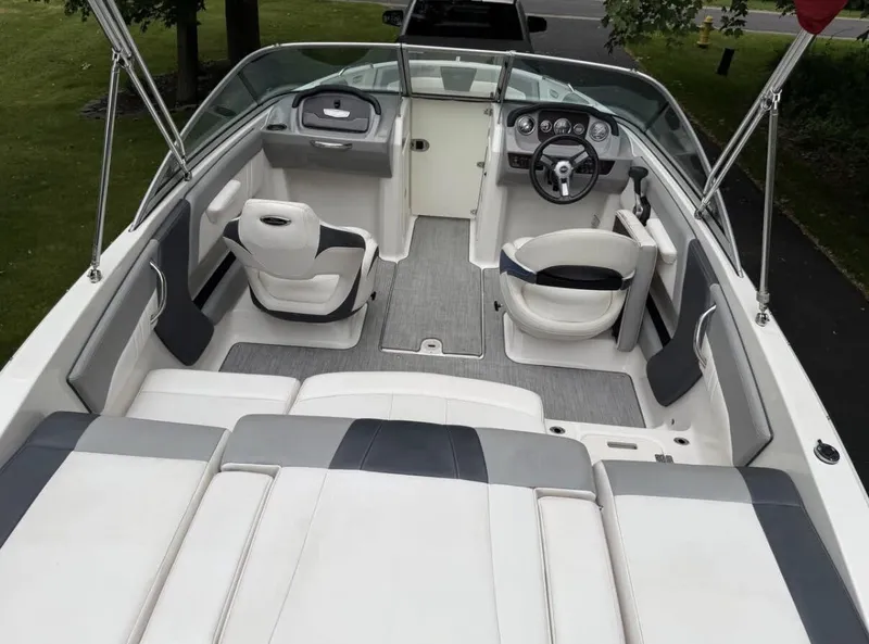 Slide: The Image of The image shows the cockpit of a 2020 Chaparral SSi 21 boat with gray and white seating. - 7