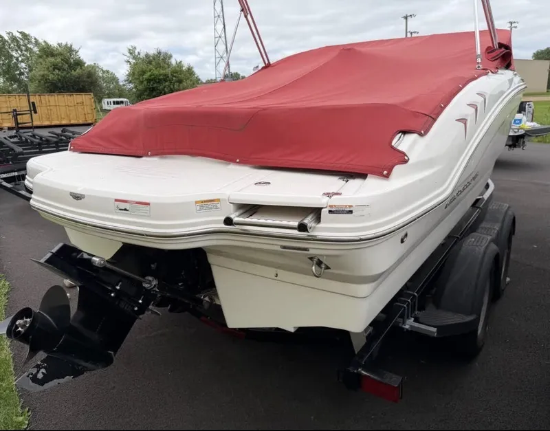 Slide: The Image of A 2020 Chaparral SSi 21 boat with a red cover on a trailer. - 3