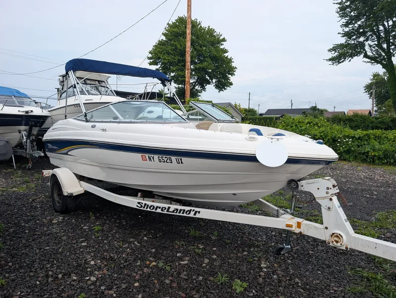 Slide: The Image of A 2002 Chaparral 183 SSE boat on a trailer in a gravel lot. - 3
