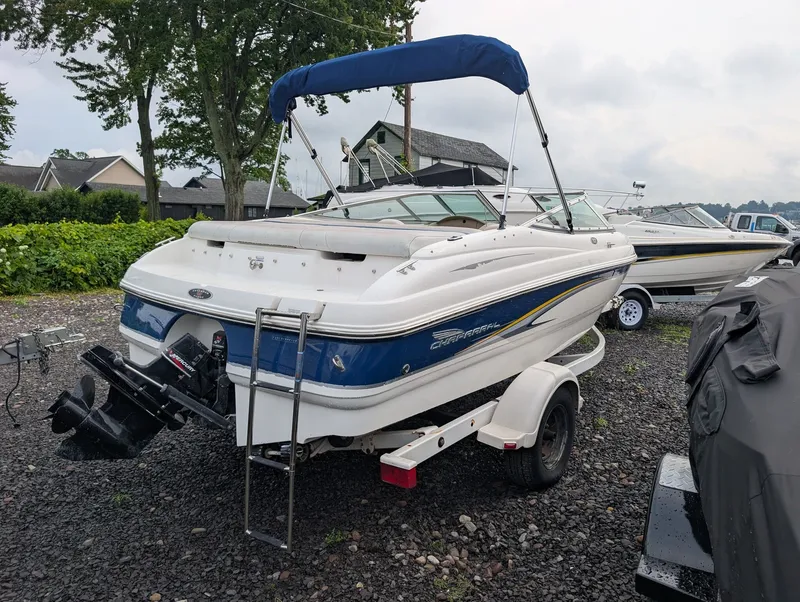 Slide: The Image of A 2002 Chaparral 183 SSE boat on a trailer. It features a blue and white design. - 4