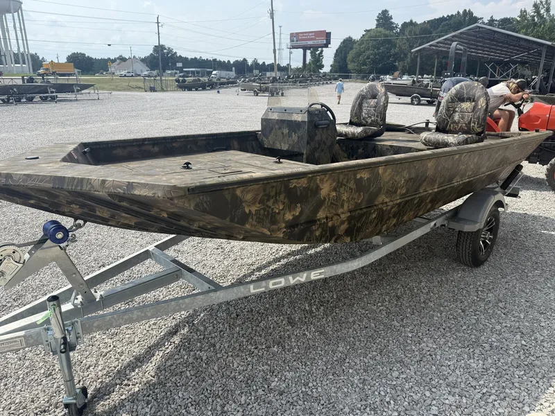 Slide: The Image of A 2027 Lowe Roughneck 1650SC boat on a trailer, featuring camouflage pattern and two seats. - 4