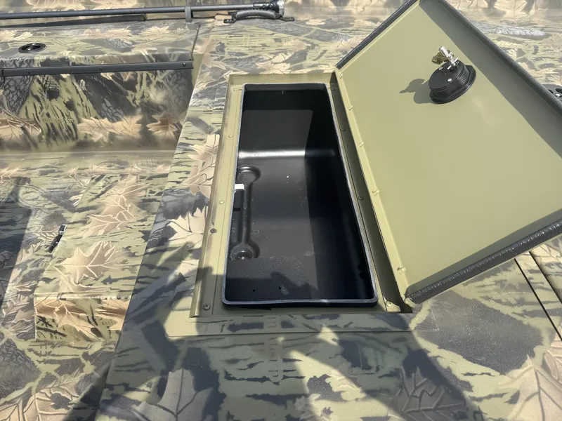 Slide: The Image of An open storage compartment on a camouflaged boat reflecting sunlight. - 2
