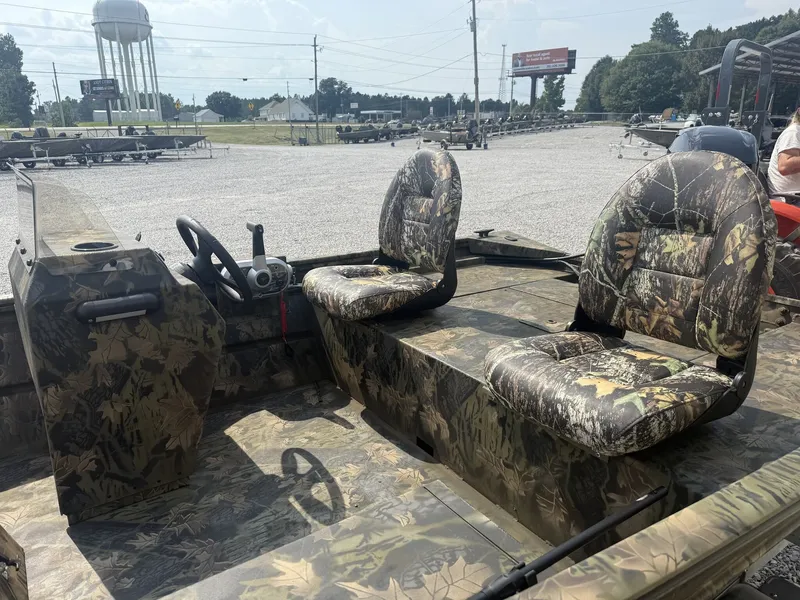 Slide: The Image of The image shows a Lowe Roughneck 1650SC boat with camo-patterned seats and a steering console. - 5