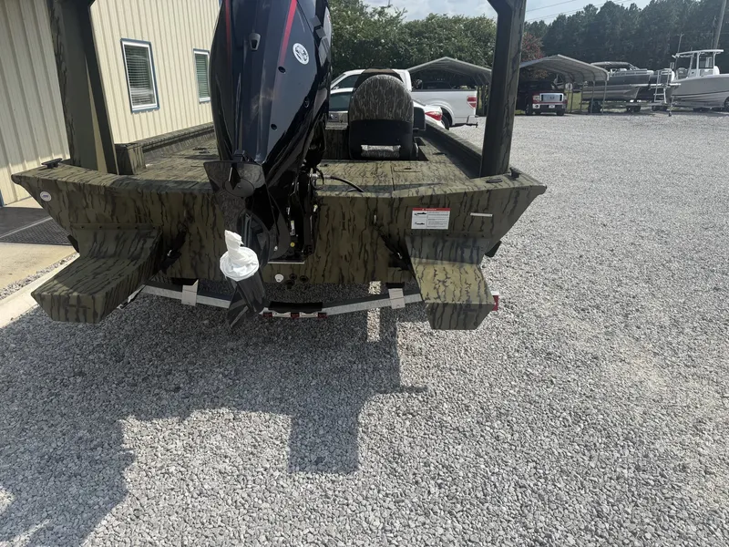 Slide: The Image of A 2027 Lowe Outlet 20-CATFISH boat on a gravel lot. The outboard motor is visible. - 4