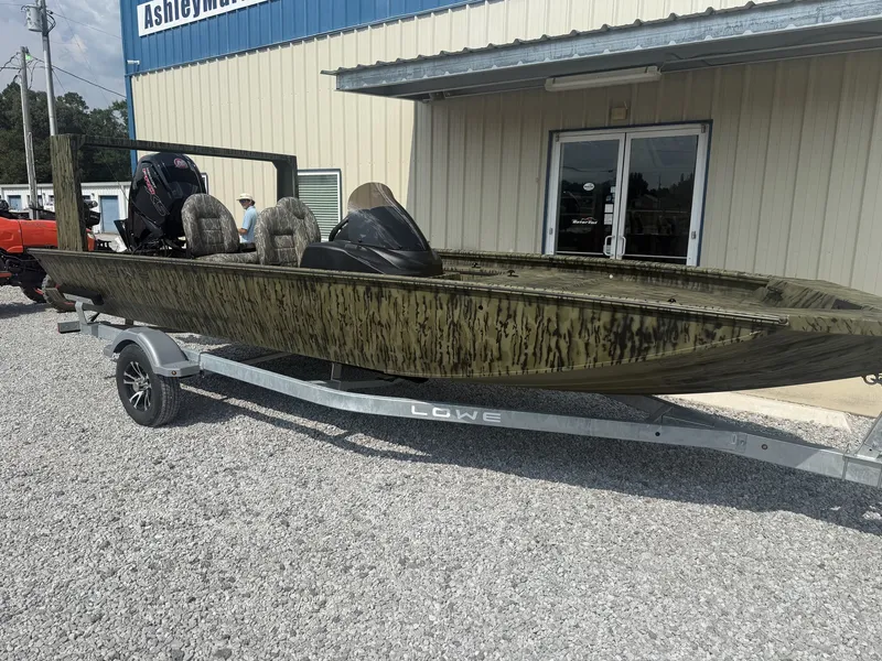 Slide: The Image of A 2027 Lowe Outlet 20-CATFISH boat on a trailer in front of a building. - 3