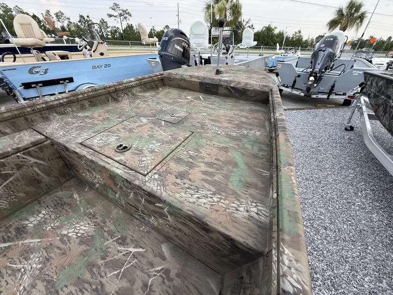 Slide: The Image of A G3 Gator Tough 15DK boat with camouflage pattern, equipped with a 40HP Yamaha engine, on a gravel lot. - 12