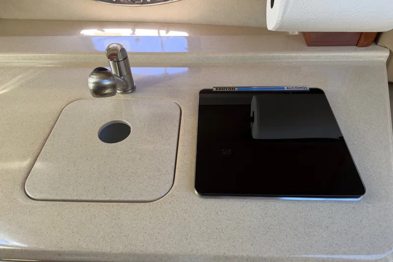 Slide: The Image of 2013 Sea Ray Sundancer 280 galley with sink and Kenyon alcohol stove. - 30