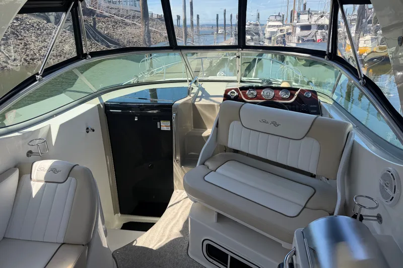 Slide: The Image of 2013 Sea Ray Sundancer 280 interior with helm, seating, and marina view. - 10
