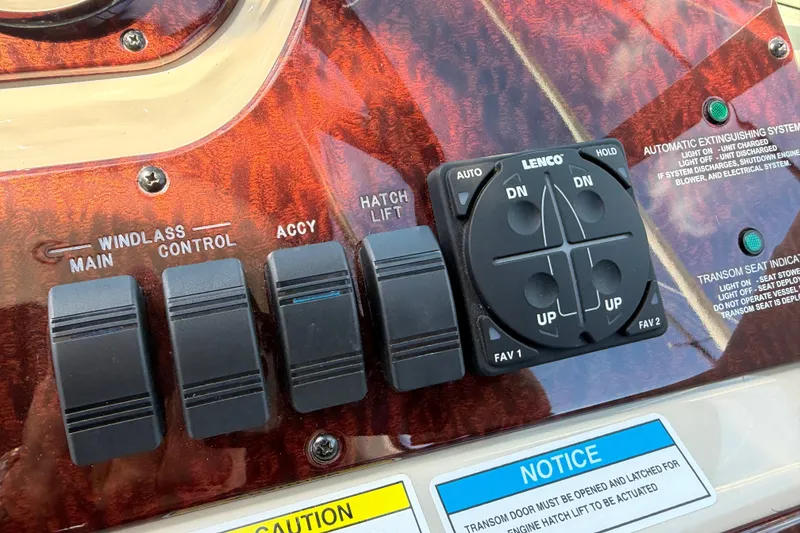 Slide: The Image of Control panel of a 2013 Sea Ray Sundancer 280 boat with switches and Lenco trim tab. - 19