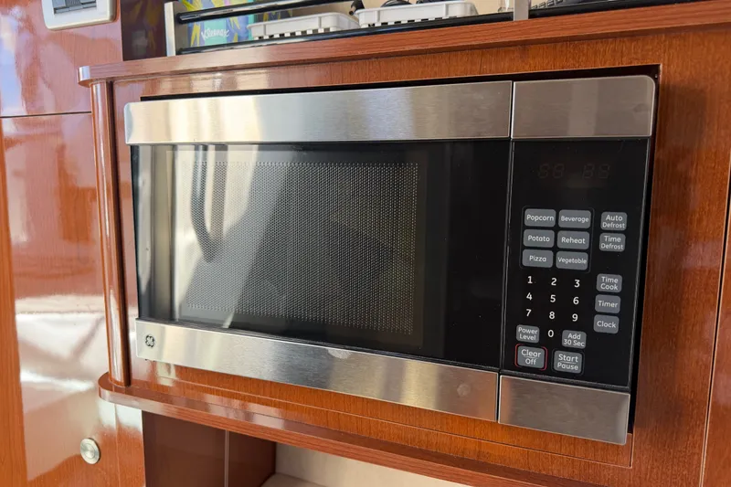 Slide: The Image of Microwave in 2013 Sea Ray Sundancer 280 yacht, featuring wood cabinetry and stainless steel finish. - 32