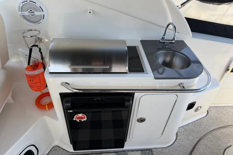 Slide: The Image of Outdoor kitchenette on 2013 Sea Ray Sundancer 280 with grill, sink, and mini fridge. - 12