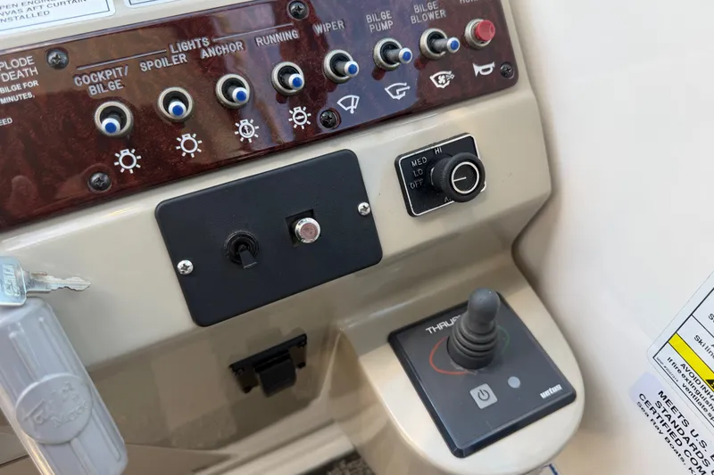 Slide: The Image of Control panel of a 2013 Sea Ray Sundancer 280 boat with various switches and joystick. - 18