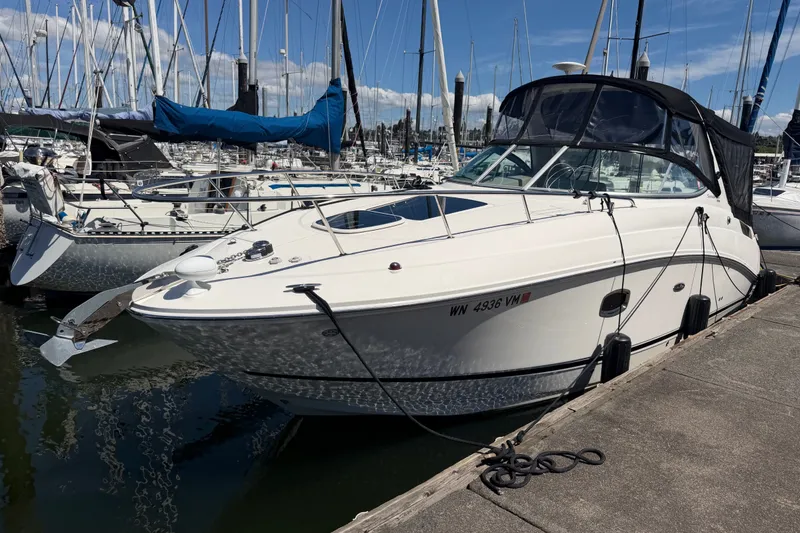 The Image of 2013 Sea Ray Sundancer 280 docked at marina, surrounded by sailboats. - 0