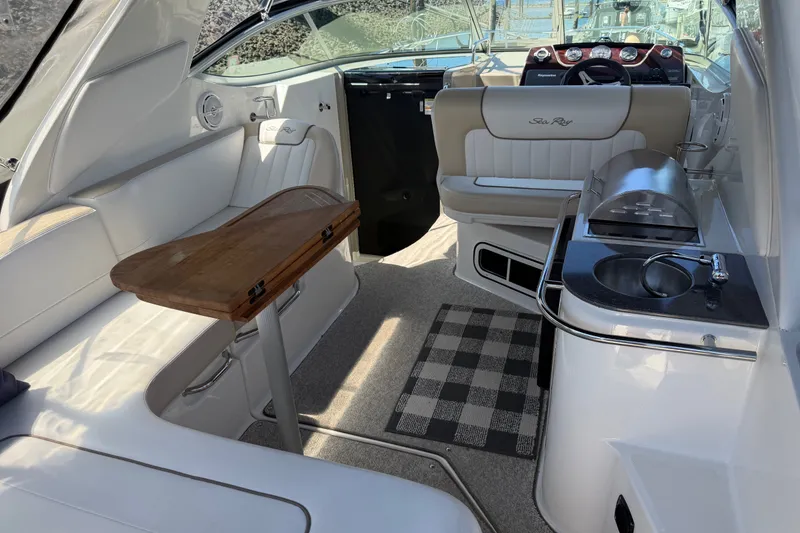 Slide: The Image of Interior of 2013 Sea Ray Sundancer 280 boat with seating, table, and kitchenette. - 3