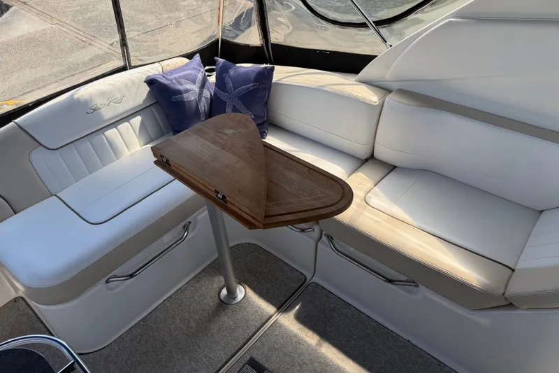Slide: The Image of Interior of 2013 Sea Ray Sundancer 280 with white seating and wooden table. - 5
