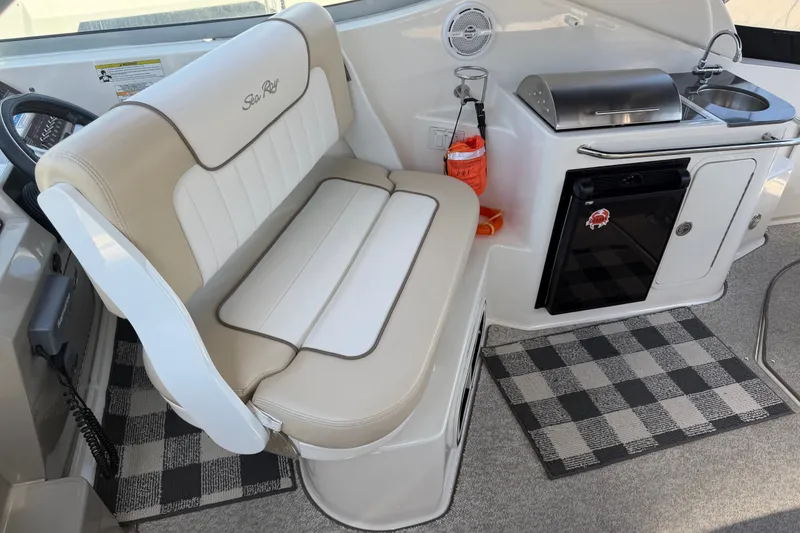 Slide: The Image of Interior of 2013 Sea Ray Sundancer 280 with seating, kitchenette, and checkered mats. - 9