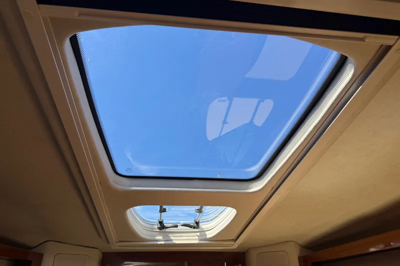 Slide: The Image of Sunroof view from 2013 Sea Ray Sundancer 280, showcasing clear blue sky. - 25