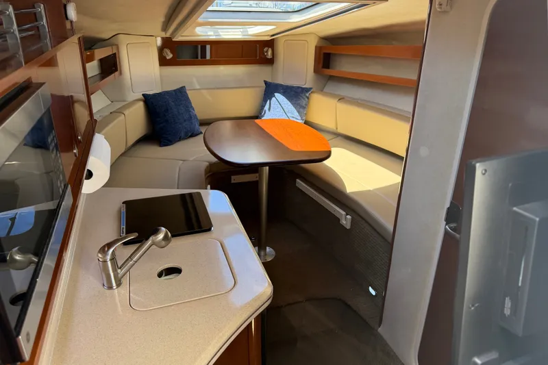 Slide: The Image of Interior of 2013 Sea Ray Sundancer 280 with kitchenette and seating area. - 22