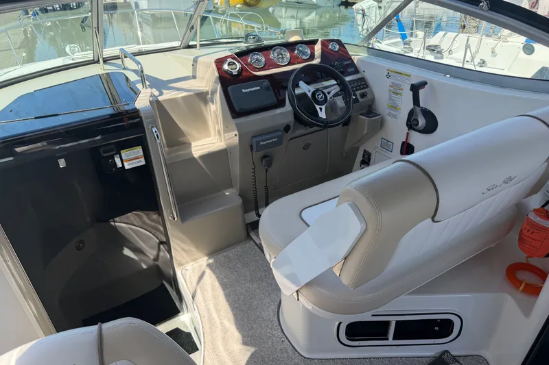 Slide: The Image of 2013 Sea Ray Sundancer 280 cockpit with steering wheel, controls, and seating. - 8