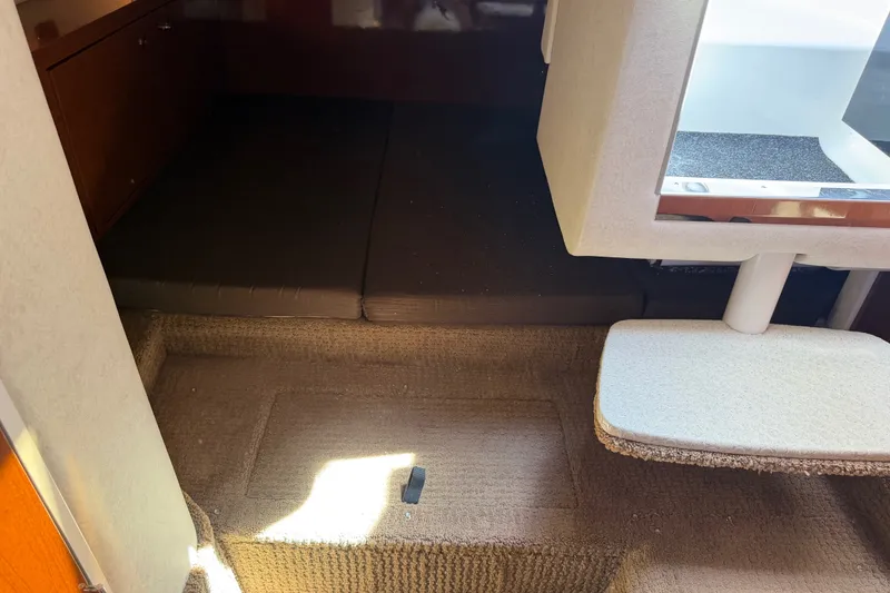 Slide: The Image of Interior cabin of 2013 Sea Ray Sundancer 280 with carpeted flooring and seating area. - 34