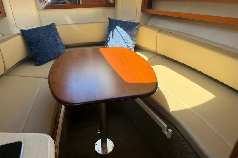 Slide: The Image of Interior of 2013 Sea Ray Sundancer 280 with cozy seating and wooden table. - 23
