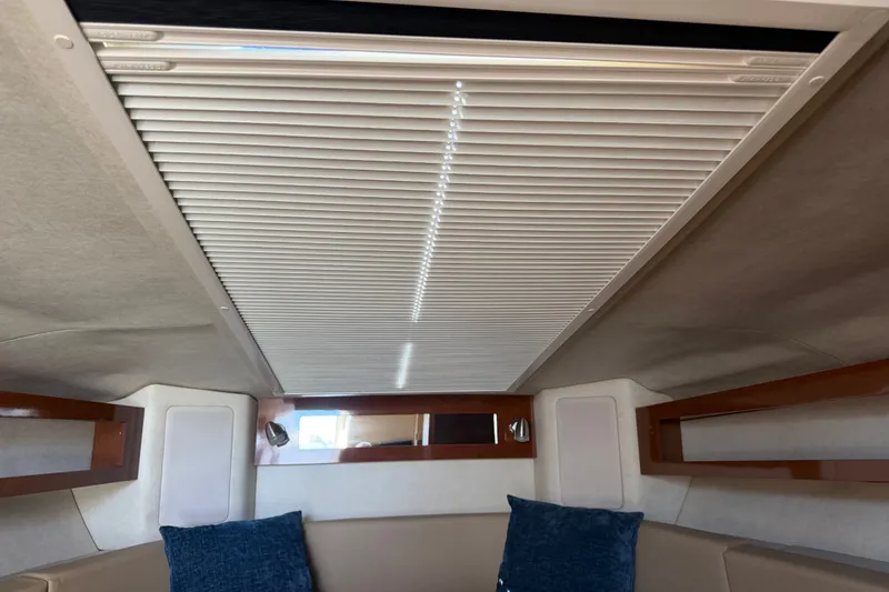 Slide: The Image of Interior cabin of 2013 Sea Ray Sundancer 280 with blue cushions and ceiling blinds. - 27