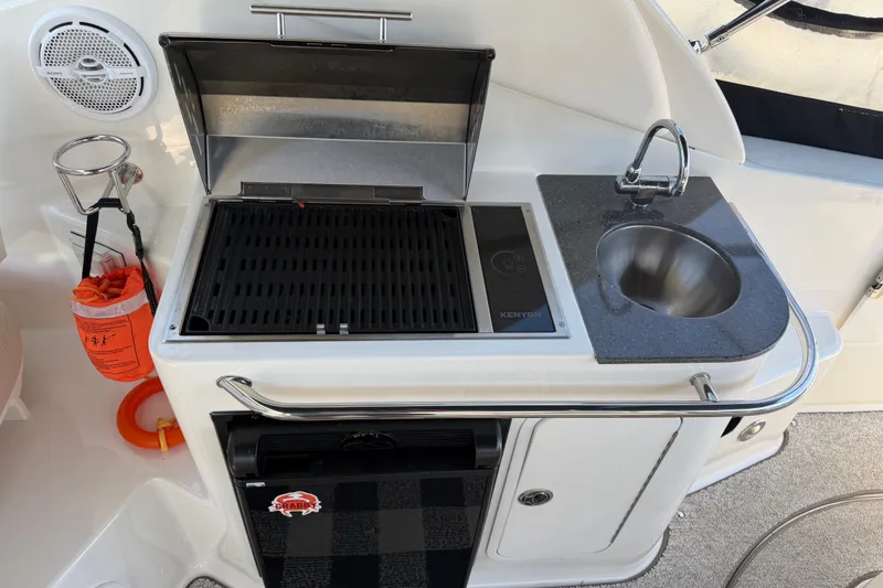 Slide: The Image of Outdoor kitchenette on 2013 Sea Ray Sundancer 280 with grill, sink, and storage. - 13