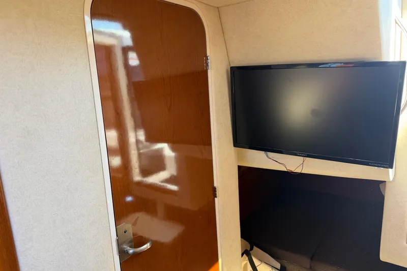 Slide: The Image of Interior of 2013 Sea Ray Sundancer 280 with TV and wooden door. - 37