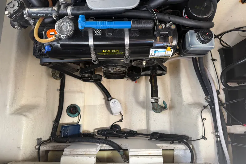 Slide: The Image of Engine compartment of a 2013 Sea Ray Sundancer 280 boat, showcasing mechanical components. - 43