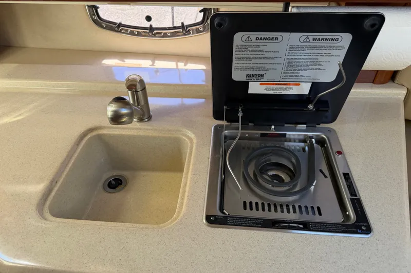 Slide: The Image of 2013 Sea Ray Sundancer 280 galley with sink and stove. - 31
