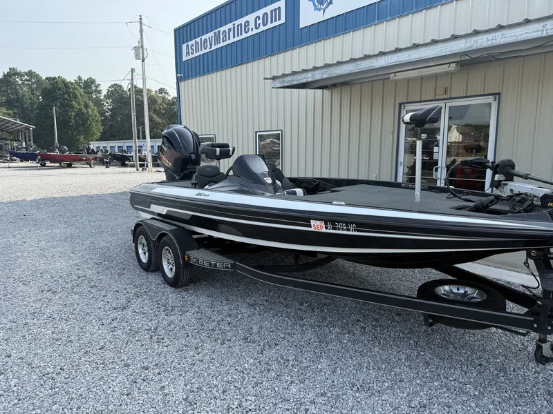 Slide: The Image of A black 2018 Skeeter ZX200 boat on a trailer in front of a building. - 4