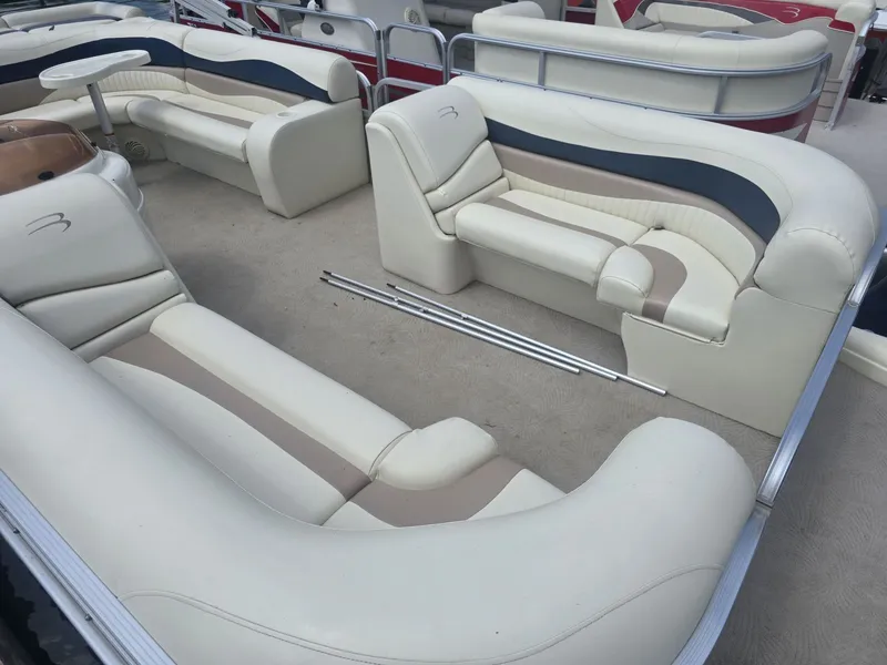 Slide: The Image of The image shows the interior of a 2008 Bennington 2050GL pontoon boat with cream-colored seating. - 3