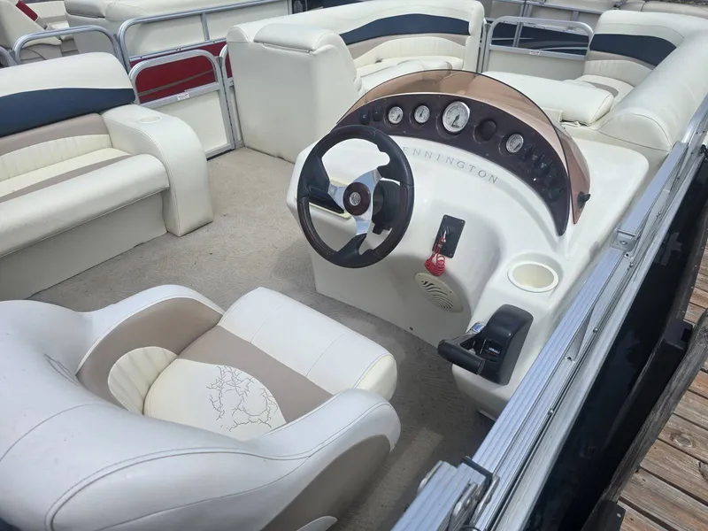 Slide: The Image of The image shows the cockpit of a 2008 Bennington 2050GL pontoon boat with beige and white seating. - 5