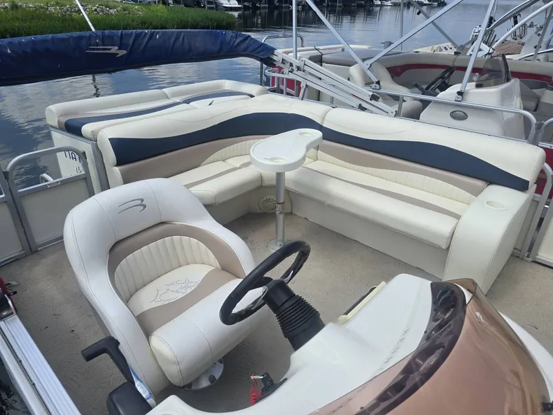 Slide: The Image of The image shows the cockpit of a 2008 Bennington 2050GL with beige and blue seating. - 4