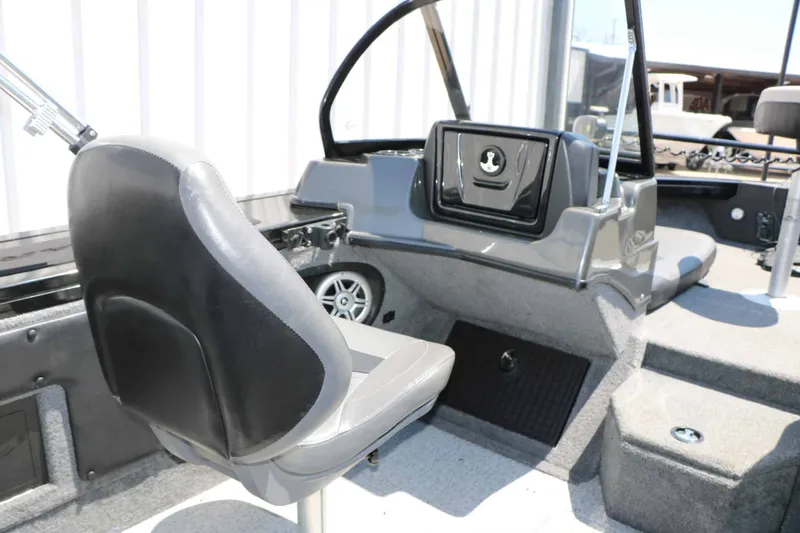 Slide: The Image of The image shows the interior of a 2020 Tracker Targa V 19 Combo boat with gray seating. - 30