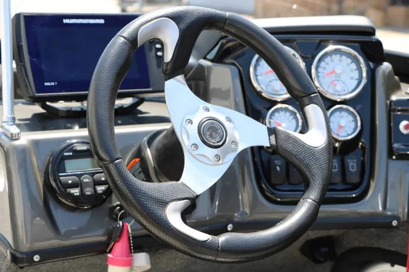 Slide: The Image of The image shows the helm of a 2020 Tracker Targa V 19 Combo boat with instruments. - 29