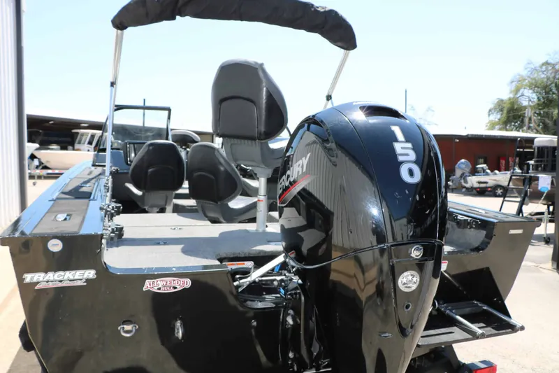 Slide: The Image of A 2020 Tracker Targa V 19 Combo with a Mercury 150 outboard motor, parked outdoors. - 6