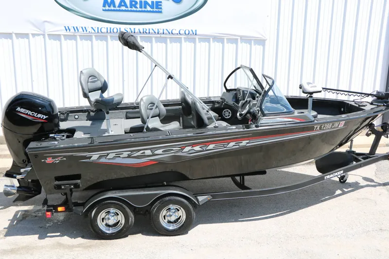 Slide: The Image of A black 2020 Tracker Targa V 19 Combo boat on a trailer. It features a Mercury outboard motor. - 14